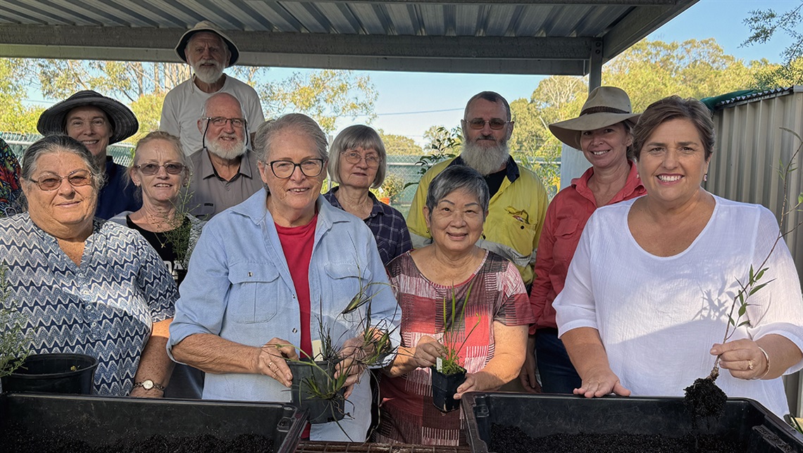 Councillor Murphy with a group of others holding plants