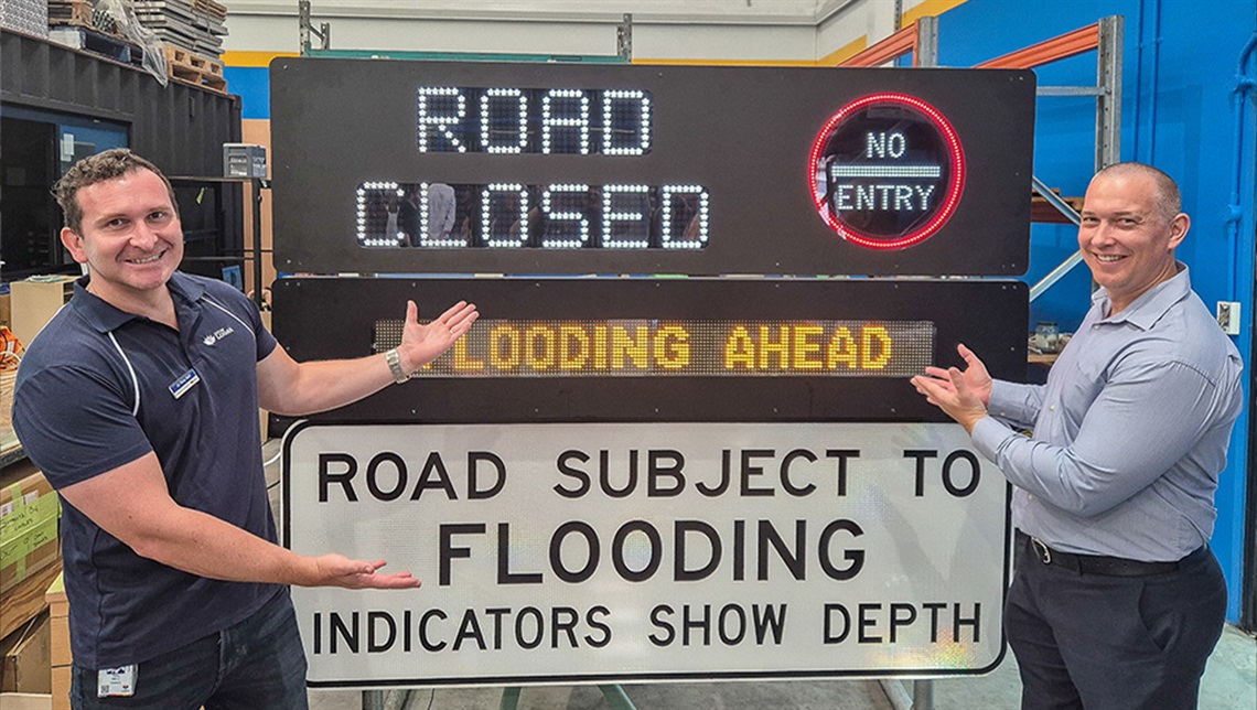 Councillors Tony Hall (left) and Tim Frazer (from Division 7) inspect an emergency road sign that is powered by recycled e-waste constructed by Substation33.