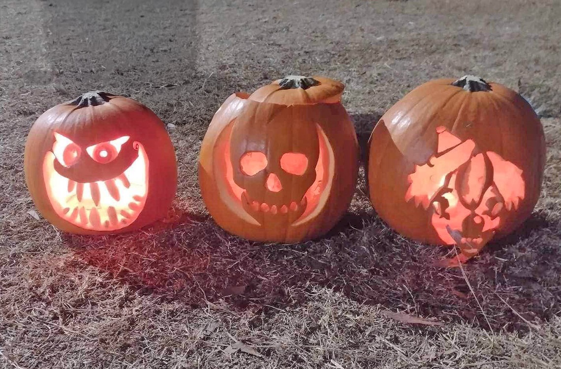 Three carved pumpkin lanterns