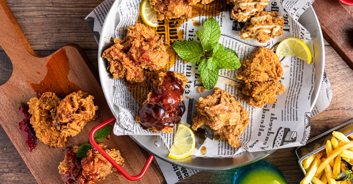 Korean fried chicken wings on a plate with garnishings