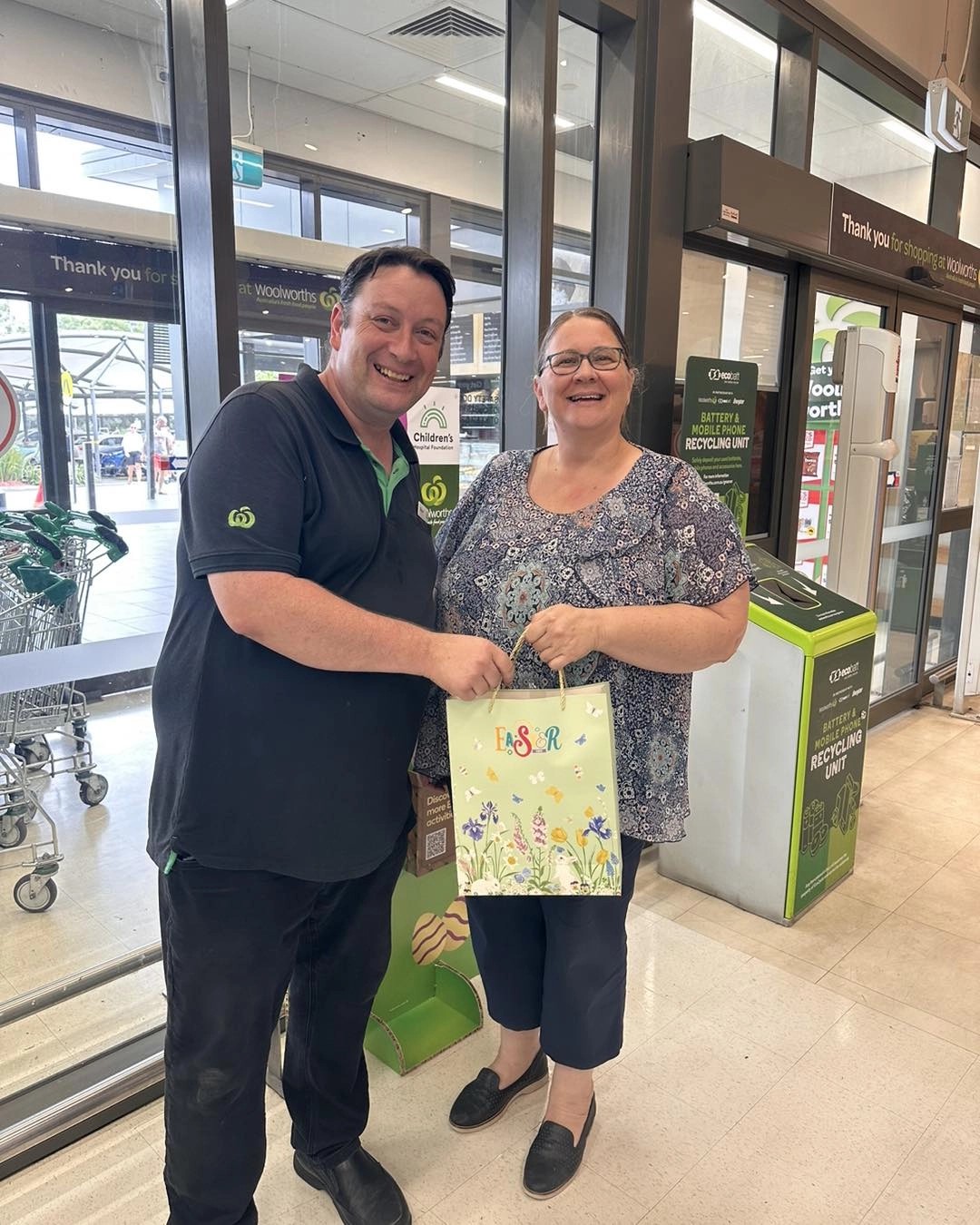 Lynda receives a donation from Woolworths for an Easter raffle