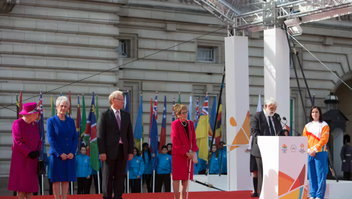 Uncle Ted Williams speaking at Buckingham Palace in London, alongside dignitaries including the late Queen Elizabeth II, standing on the left.