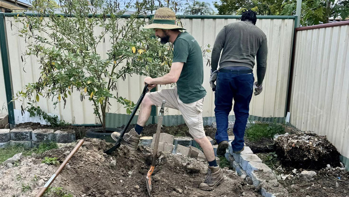 A group of locals helping out a neighbour by doing some landscaping