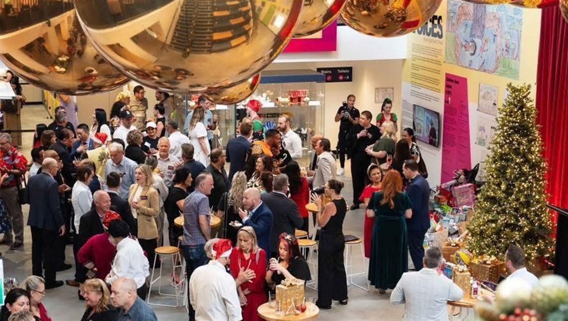 A group of people celebrating christmas in a decorated room with a christmas tree