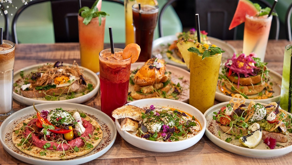 A variety of food dishes and drinks organised on a table