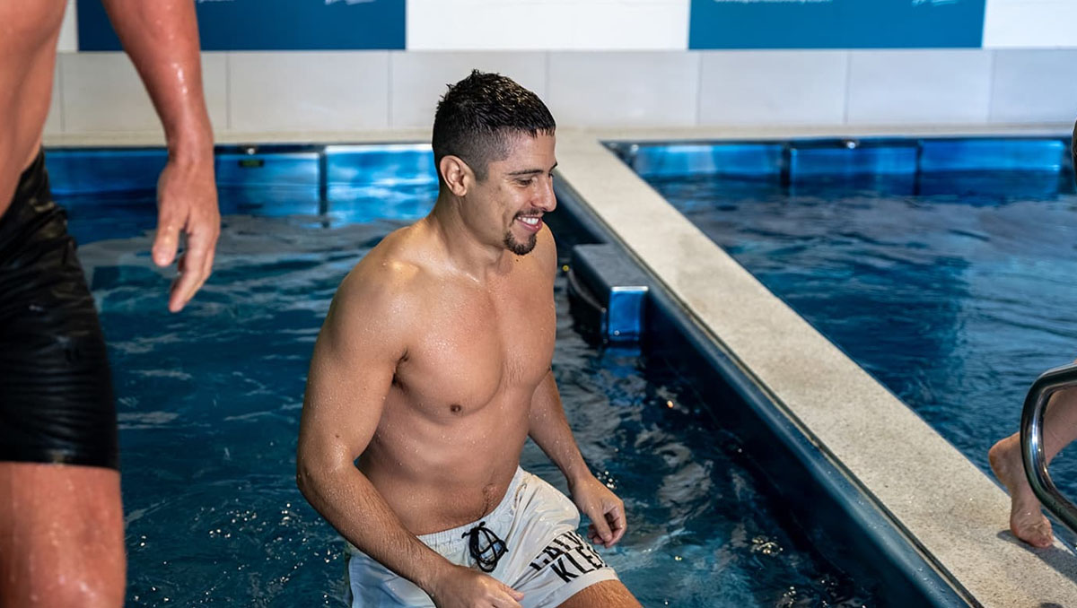 A man getting out of a pool