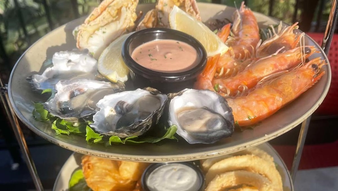A plate of seafood, oysters, prawns, bugs, calamari