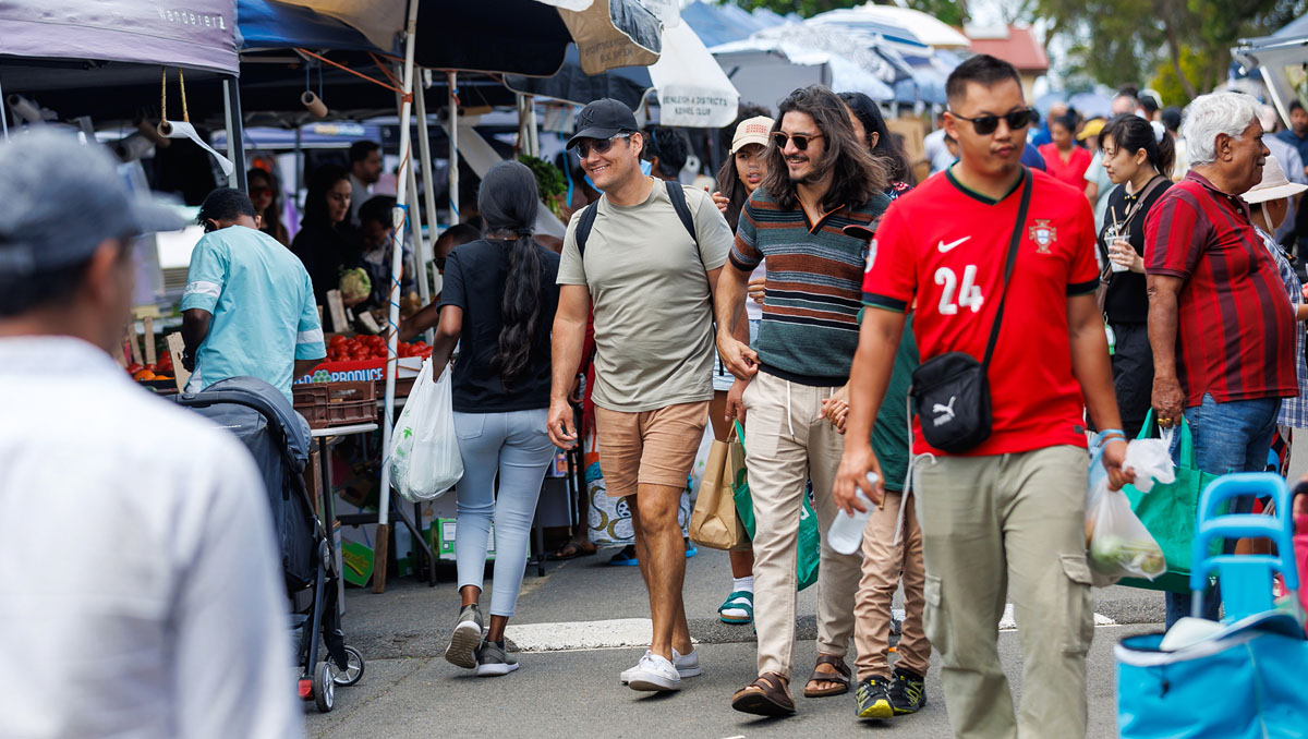 A group of people strolling through the Global Food Markets