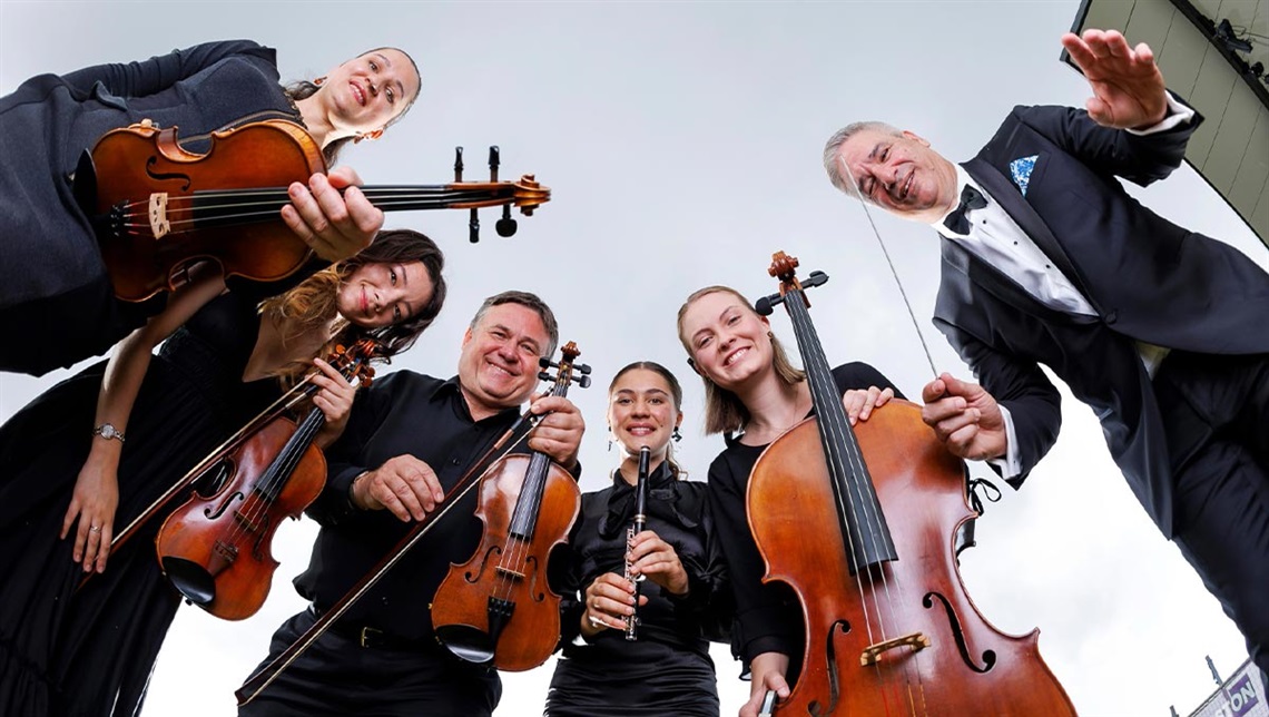 Logan City Orchestra holding their instruments