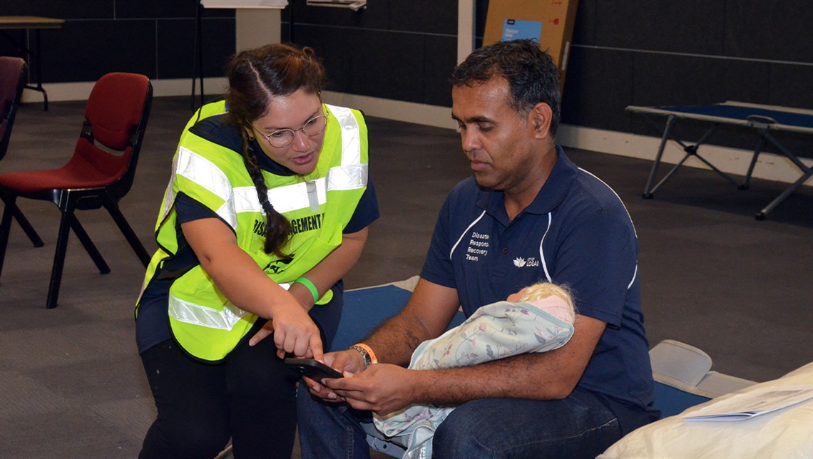 Logan City Council staff members Grace Elliott and Ajnesh Achal test their evacuation centre skills at Logan West Community Centre.