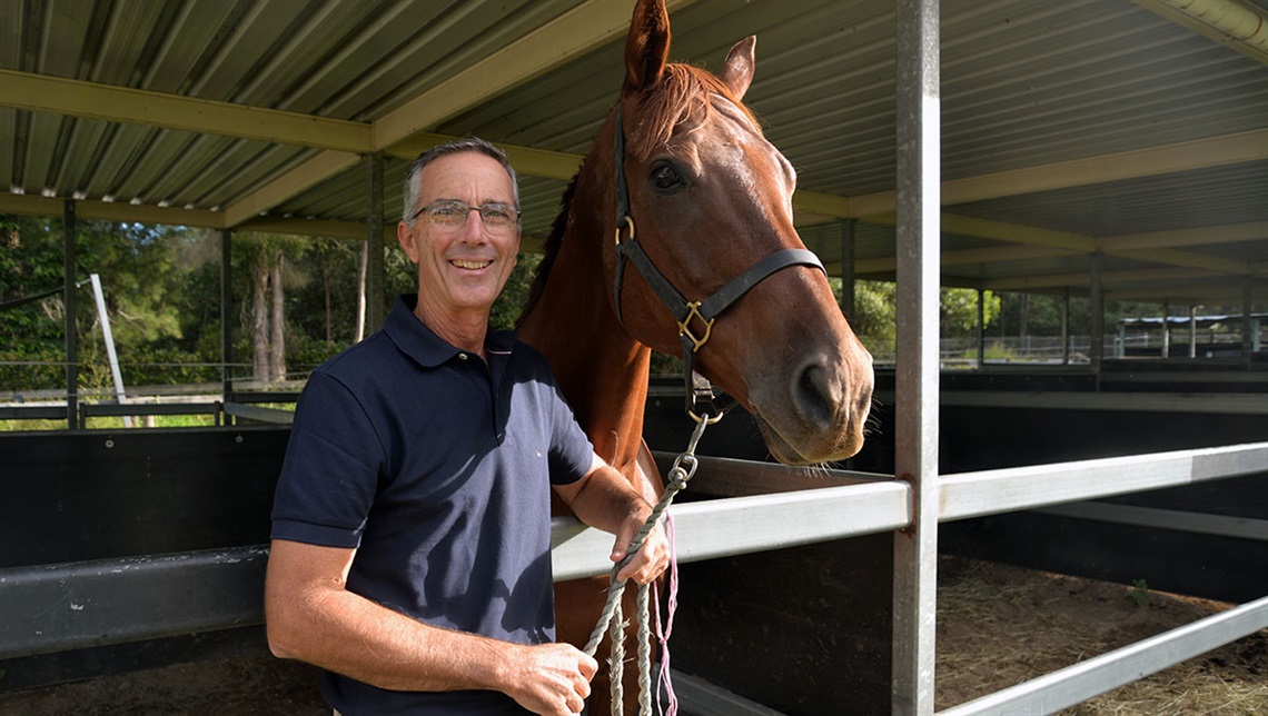 Councillor Jackson standing holding a horse