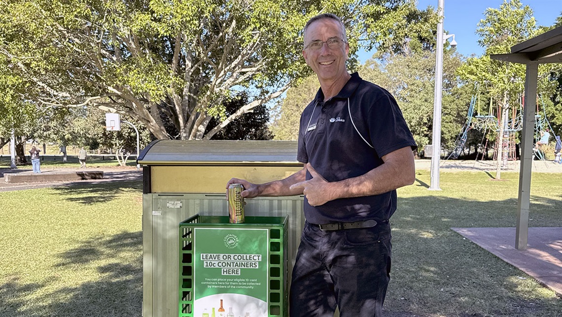 Councillor Jackson putting a can into a new container bin