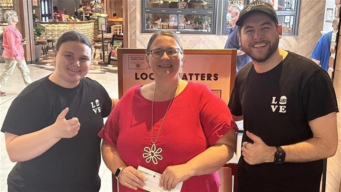 Lynda receiving a donation from Grill’d Browns Plains.
