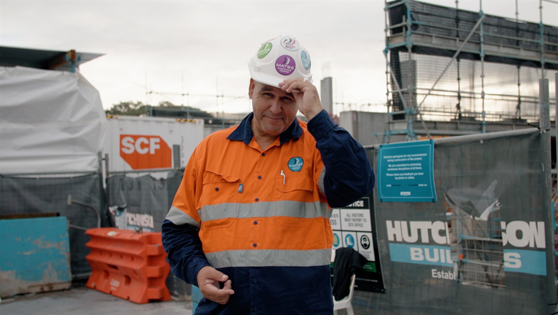 Justin Geange standing on front of a construction site