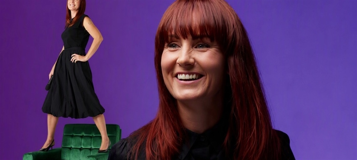Comedy hypnotist Krystal Brown on a purple background and standing on a green lounge chair